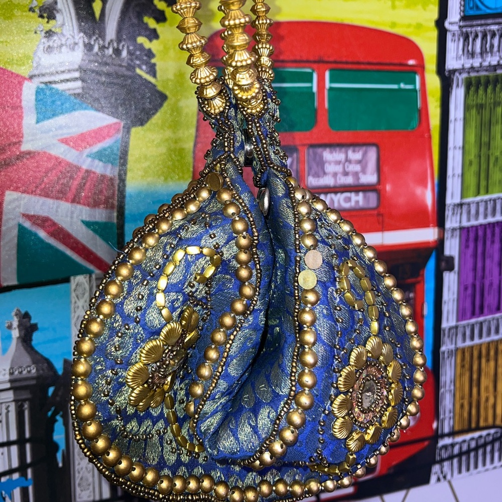 Beautiful Cato Purse in Blue and Gold with a Stylish Circle Handle.